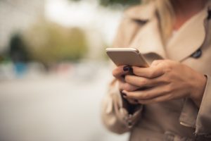 Woman using mobile away from home